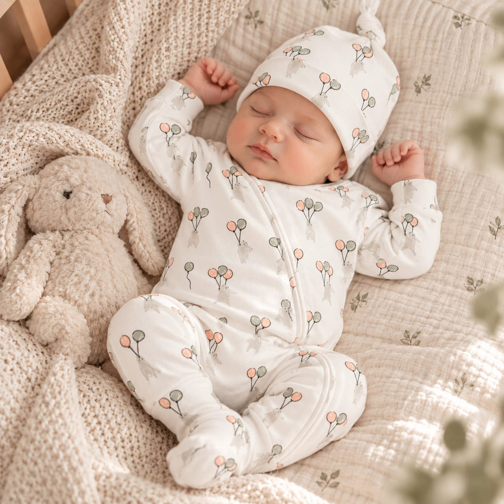 Baby in neutral-tone Tiny Twig organic cotton